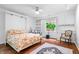 Bright bedroom features built-in cabinets, a ceiling fan, and a window for natural light and ventilation at 504 Bent Tree Ln, Indianapolis, IN 46260