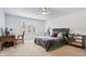 Bright bedroom with a ceiling fan, plantation shutters, and carpet floors at 504 Bent Tree Ln, Indianapolis, IN 46260