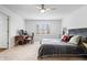 Bedroom with plush carpet, stylish furnishings, and natural light streaming through the shuttered windows at 504 Bent Tree Ln, Indianapolis, IN 46260