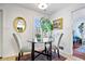 Cozy breakfast nook with glass table, upholstered chairs, and window with plantation shutters at 504 Bent Tree Ln, Indianapolis, IN 46260