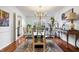 Traditional dining room with glass top dining table and chandelier and a window view at 504 Bent Tree Ln, Indianapolis, IN 46260
