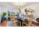 Dining room with chandelier and glass top dining table and many potted plants at 504 Bent Tree Ln, Indianapolis, IN 46260