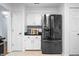 Bright kitchen area with stainless steel refrigerator and white cabinets, offering modern convenience and style at 504 Bent Tree Ln, Indianapolis, IN 46260