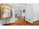 Inviting living room with hardwood floors and white walls with a glimpse of a bookcase at 504 Bent Tree Ln, Indianapolis, IN 46260