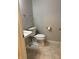 Cozy half bathroom featuring a modern toilet and sink with tile flooring, perfect for guests at 504 Elkhart Dr, Westfield, IN 46074