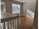 Upstairs bedroom with natural light, wood-like flooring, and neutral gray walls at 504 Elkhart Dr, Westfield, IN 46074