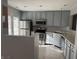 Well-lit kitchen featuring stainless steel appliances, gray cabinetry, and a functional layout at 504 Elkhart Dr, Westfield, IN 46074