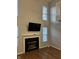 Living room features tall windows and a fireplace with mounted TV, perfect for entertaining or relaxing at 504 Elkhart Dr, Westfield, IN 46074