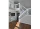 Spacious living area with hardwood floors, staircase and railing, and great natural light at 504 Elkhart Dr, Westfield, IN 46074