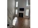 Living room features tall windows and a fireplace with mounted TV, perfect for entertaining or relaxing at 504 Elkhart Dr, Westfield, IN 46074