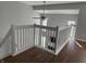 Upstairs loft featuring white railings and laminate flooring that overlooks the living space below at 504 Elkhart Dr, Westfield, IN 46074