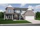 Charming two-story home featuring a brick and siding facade, attached garage, and well-manicured front lawn at 505 Tess Blvd, Westfield, IN 46074