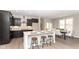 Modern kitchen featuring sleek black cabinets, stainless steel appliances, and a center island with bar seating at 505 Tess Blvd, Westfield, IN 46074
