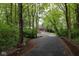 Scenic view of a home at the end of a long driveway surrounded by lush greenery at 5125 E 79Th St, Indianapolis, IN 46250