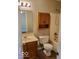 Bathroom features a shower-tub combo, a vanity with sink, and wood storage cabinets at 5822 Blackley Ln, Indianapolis, IN 46254