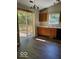 Kitchenette with access to a back deck, vinyl floors, wood cabinets and white countertops at 5822 Blackley Ln, Indianapolis, IN 46254
