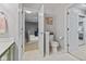 A full bathroom showcasing a toilet and vanity with neutral paint, tile floors, and natural light at 5839 Beacon Cove Way, Indianapolis, IN 46237