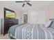 Neutral bedroom with ceiling fan, large bed, carpeted floor, and a TV at 5839 Beacon Cove Way, Indianapolis, IN 46237
