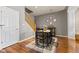 Charming dining area featuring a dark wood table and chairs, hardwood floors, and a staircase at 5839 Beacon Cove Way, Indianapolis, IN 46237