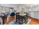 Bright dining area with an open layout, hardwood floors, and a view of the living room and kitchen at 5839 Beacon Cove Way, Indianapolis, IN 46237