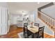 Well-lit dining area featuring hardwood floors, modern decor, and staircase access at 5839 Beacon Cove Way, Indianapolis, IN 46237