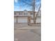 Traditional townhome featuring a two-car garage, light beige siding, and a manicured front yard at 5839 Beacon Cove Way, Indianapolis, IN 46237