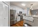Modern kitchen featuring stainless steel appliances, white cabinetry, and granite countertops at 5839 Beacon Cove Way, Indianapolis, IN 46237