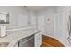 Galley kitchen showcasing granite counters, stainless appliances, and white cabinets at 5839 Beacon Cove Way, Indianapolis, IN 46237