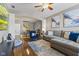 Spacious living room with hardwood floors, a blue accent chair, and an open archway to the dining area at 5839 Beacon Cove Way, Indianapolis, IN 46237
