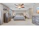 Calm main bedroom boasts a ceiling fan, dresser, and neutral carpeting at 5839 Beacon Cove Way, Indianapolis, IN 46237