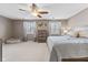 Main bedroom with neutral carpet, natural light, ceiling fan, and decor at 5839 Beacon Cove Way, Indianapolis, IN 46237