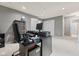 Well-lit home office with plush carpet, desk, and built-in storage at 5839 Beacon Cove Way, Indianapolis, IN 46237