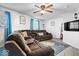 Comfortable living room featuring plush sofas, ceiling fan, and bright window views at 637 Woods Crossing Dr, Indianapolis, IN 46239