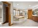 This bathroom has a raised jacuzzi tub, tile flooring, and wood trim around the window and doors at 6520 Forrest Commons Blvd, Indianapolis, IN 46227