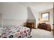 Cozy bedroom under the eaves featuring carpeted floors, a vintage desk, and lots of natural light at 6520 Forrest Commons Blvd, Indianapolis, IN 46227