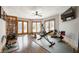 Well-lit exercise room with wood floors, various workout equipment and access to the outdoors at 6520 Forrest Commons Blvd, Indianapolis, IN 46227