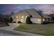 Attractive single story home features a large front yard, beautiful windows, and lovely landscaping at 6520 Forrest Commons Blvd, Indianapolis, IN 46227
