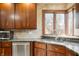 Kitchen featuring granite countertops, stainless steel appliances and a window overlooking the yard at 6520 Forrest Commons Blvd, Indianapolis, IN 46227