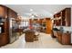 Bright kitchen includes stainless steel appliances, dark cabinetry, and an island with seating at 6520 Forrest Commons Blvd, Indianapolis, IN 46227