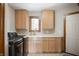 Laundry room featuring light wood cabinets, ample counter space, and modern appliances at 6520 Forrest Commons Blvd, Indianapolis, IN 46227