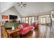 Open concept living room with tile floors, statement furniture, and arched windows overlooking the yard at 6520 Forrest Commons Blvd, Indianapolis, IN 46227