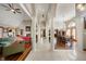 Open concept living room with tile floors, fireplace, and stately columns leading into dining area at 6520 Forrest Commons Blvd, Indianapolis, IN 46227