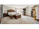Spacious primary bedroom suite with carpet flooring, wooden furnishings, and natural light from bay windows at 6520 Forrest Commons Blvd, Indianapolis, IN 46227
