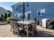 Back patio with dining table, grill, and umbrella at 664 Hythe Way, Westfield, IN 46074