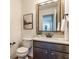 Elegant powder room featuring a decorative mirror, stylish vanity, and modern fixtures, adding sophistication at 664 Hythe Way, Westfield, IN 46074