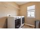 The laundry room features front loading washer/dryer and ample lighting at 664 Hythe Way, Westfield, IN 46074