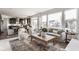 Open-concept living space with large windows, seamlessly connecting indoor and outdoor living, and modern furnishings at 664 Hythe Way, Westfield, IN 46074