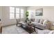 Cozy living room with neutral tones, large windows, and stylish furniture at 664 Hythe Way, Westfield, IN 46074
