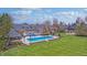 Expansive backyard featuring a pool, patio, outdoor structure, and green lawn at 6778 Old Hunt Club Rd, Zionsville, IN 46077