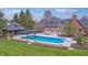Stunning backyard with swimming pool, outdoor seating, and lovely landscaping at 6778 Old Hunt Club Rd, Zionsville, IN 46077